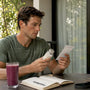 Runner reviewing magnesium supplement bottle indoors