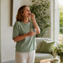 Woman taking magnesium supplement in kitchen