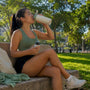 Runner holding magnesium supplement bottle on bench