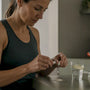 Runner opening magnesium capsule with glass of water