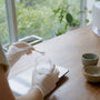 Gloved hand measuring powder sample in lab