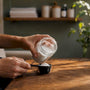 Hands preparing magnesium supplement dose on table