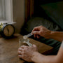 Hands measuring magnesium supplement near bedside