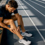 Runner massaging calf after sudden cramp