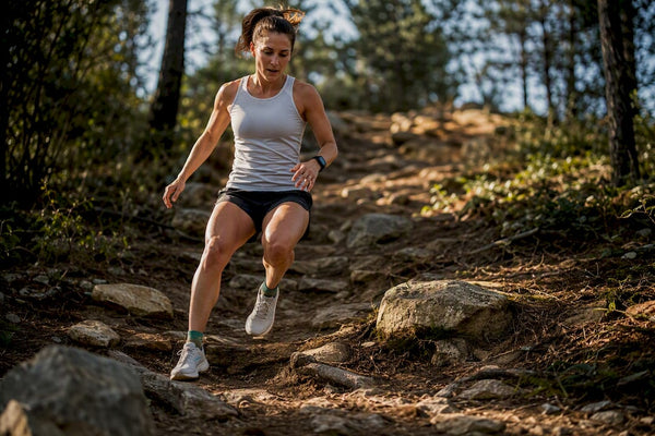 Runner descending a steep trail