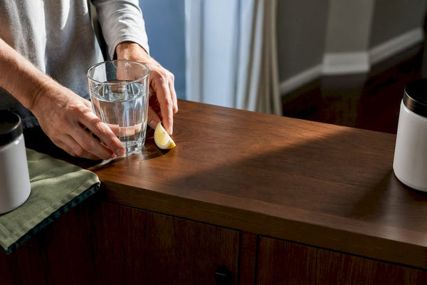Separated mineral supplements beside morning water