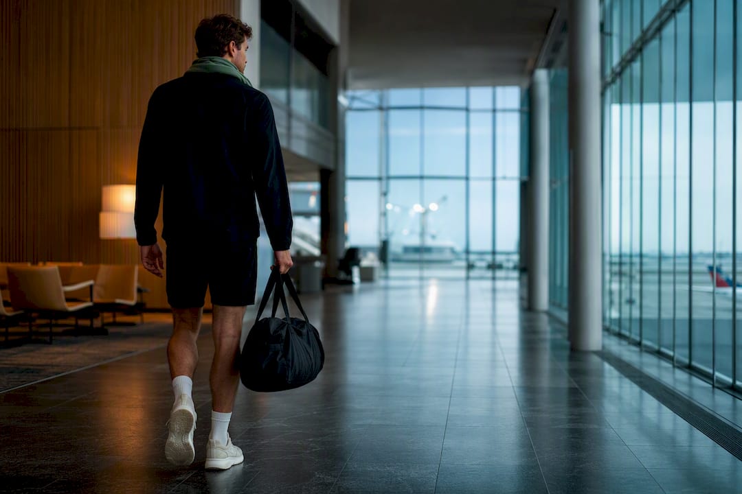 Runner walking through airport after travel