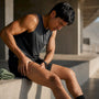 Runner tending sore quadriceps after marathon