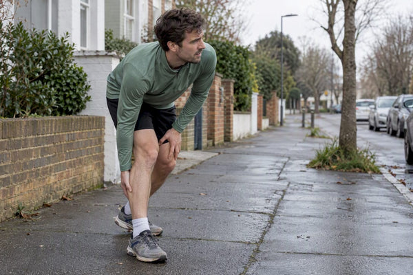 Runner pausing with a painful calf cramp